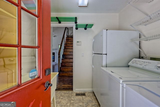 967 Saddle Gap Dr, Clayton, GA 30525 - laundry room with separate washer and dryer and light tile patterned flooring