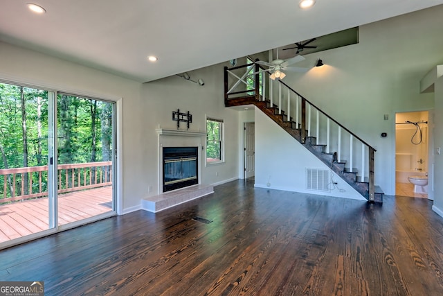 967 Saddle Gap Dr, Clayton, GA 30525 - unfurnished living room featuring healthy amount of natural light, wood finished floors, a ceiling fan, stairs, and recessed lighting