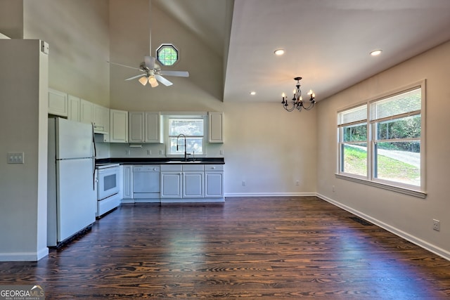 967 Saddle Gap Dr, Clayton, GA 30525 - kitchen with white appliances, dark countertops, a chandelier, dark wood finished floors, and ceiling fan