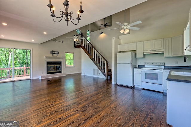 967 Saddle Gap Dr, Clayton, GA 30525 - kitchen featuring white appliances, under cabinet range hood, dark countertops, a ceiling fan, and open floor plan