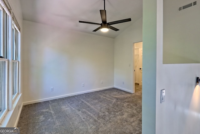 967 Saddle Gap Dr, Clayton, GA 30525 - unfurnished bedroom featuring dark carpet, multiple windows, lofted ceiling, a walk in closet, and a ceiling fan
