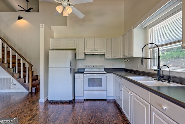967 Saddle Gap Dr, Clayton, GA 30525 - kitchen featuring white appliances, under cabinet range hood, dark wood-style floors, a ceiling fan, and a high ceiling