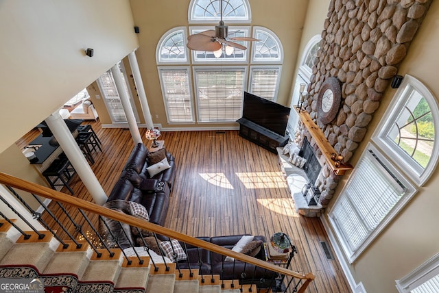 1770 Whippoorwill Rd, Watkinsville, GA 30677 - living room with a ceiling fan, a fireplace, hardwood / wood-style flooring, and a towering ceiling