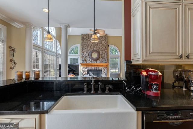 1770 Whippoorwill Rd, Watkinsville, GA 30677 - kitchen with black dishwasher, decorative columns, backsplash, a fireplace, and crown molding