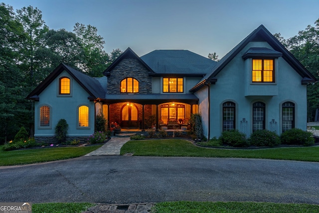 1770 Whippoorwill Rd, Watkinsville, GA 30677 - french country home with stucco siding, a front lawn, a porch, and stone siding