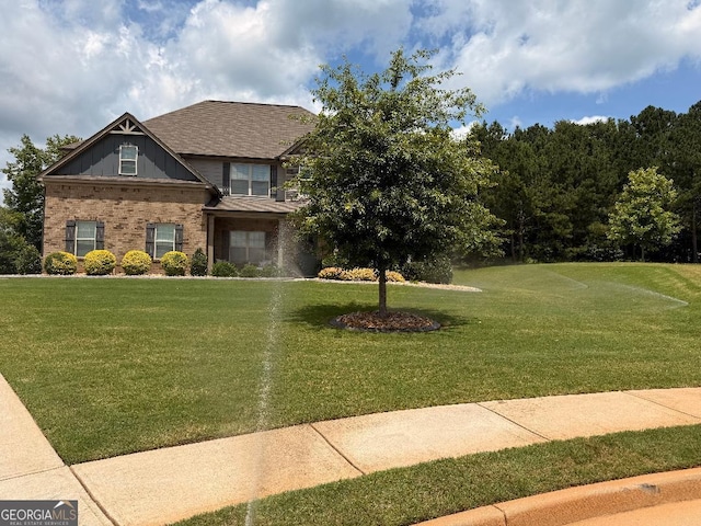 173 Lavender Way, Mcdonough, GA 30252 - view of front of home with brick siding, a front yard, and roof with shingles