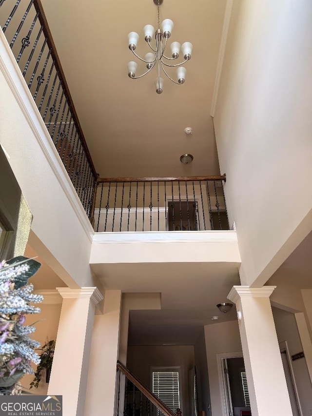 173 Lavender Way, Mcdonough, GA 30252 - stairway with a high ceiling, decorative columns, a chandelier, and ornamental molding