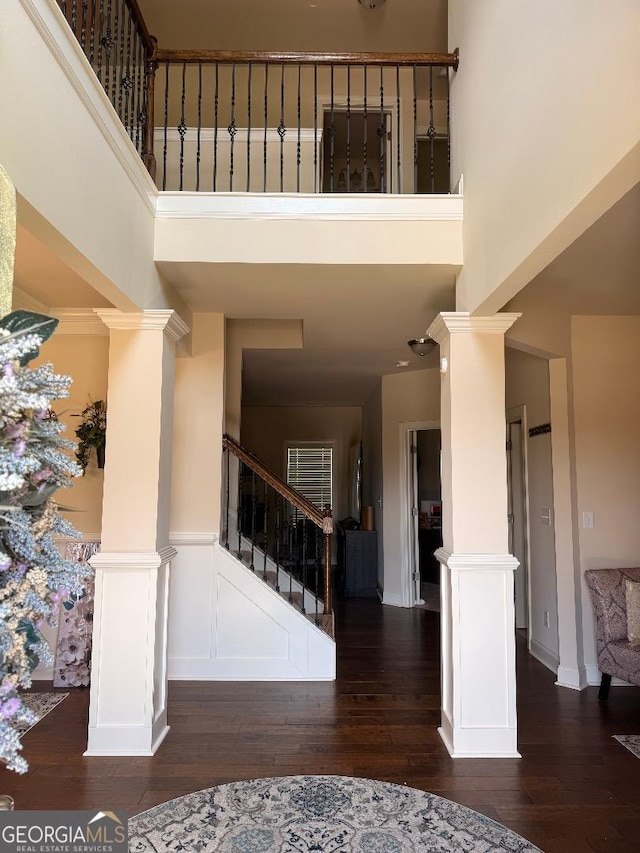 173 Lavender Way, Mcdonough, GA 30252 - foyer entrance featuring a high ceiling, decorative columns, hardwood / wood-style floors, and stairs