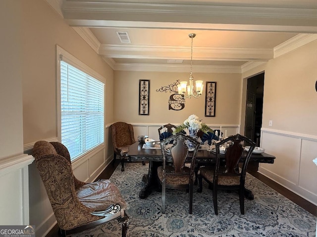 173 Lavender Way, Mcdonough, GA 30252 - dining room featuring a chandelier, a decorative wall, crown molding, wood finished floors, and wainscoting