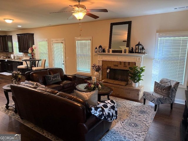 173 Lavender Way, Mcdonough, GA 30252 - living room featuring ceiling fan, dark wood finished floors, and a fireplace
