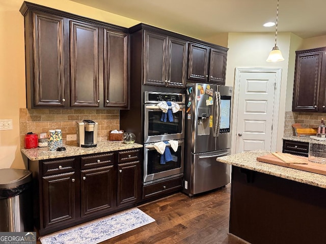 173 Lavender Way, Mcdonough, GA 30252 - kitchen featuring appliances with stainless steel finishes, dark wood-type flooring, dark brown cabinets, decorative backsplash, and recessed lighting