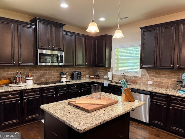 173 Lavender Way, Mcdonough, GA 30252 - kitchen with appliances with stainless steel finishes, decorative backsplash, light stone countertops, dark wood-style floors, and dark brown cabinetry