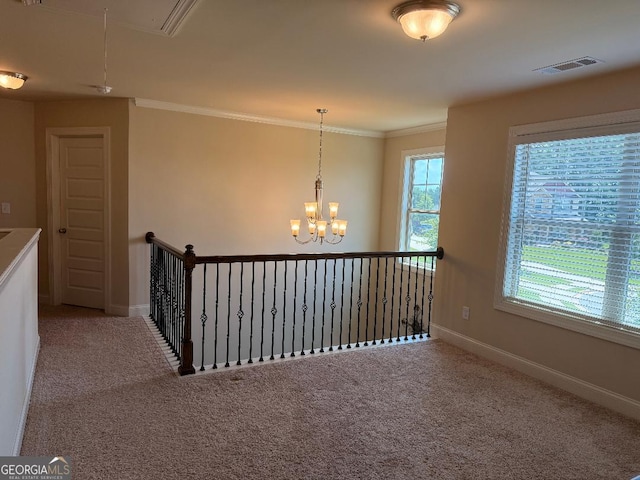 173 Lavender Way, Mcdonough, GA 30252 - hallway featuring attic access, carpet flooring, a chandelier, ornamental molding, and an upstairs landing