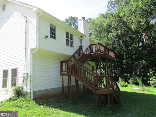 181 Thorpe Rd, Jackson, GA 30233 - back of house featuring stairway, a wooden deck, a chimney, and a yard
