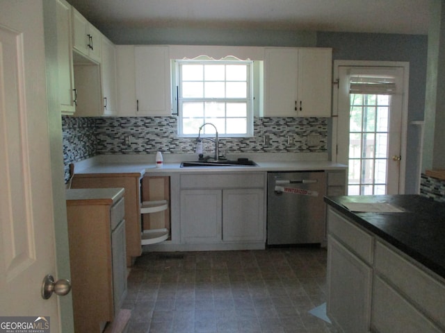 181 Thorpe Rd, Jackson, GA 30233 - kitchen with stainless steel dishwasher, backsplash, healthy amount of natural light, and white cabinetry