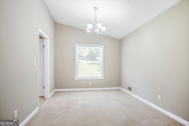 717 Raven Springs Trl, Stone Mountain, GA 30087 - spare room with a chandelier, light colored carpet, and vaulted ceiling