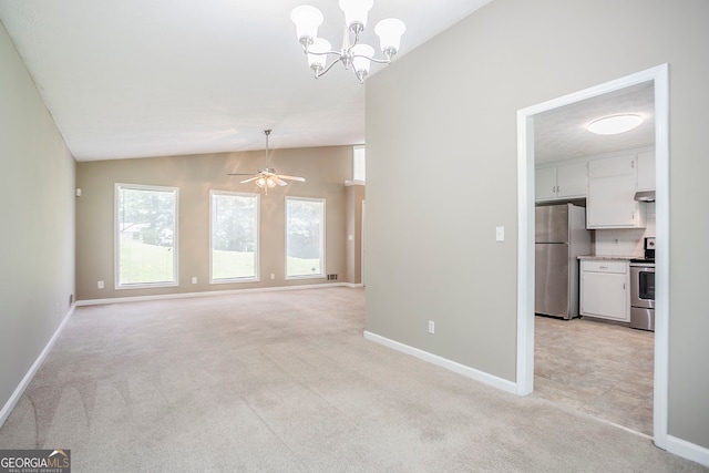 717 Raven Springs Trl, Stone Mountain, GA 30087 - unfurnished living room featuring vaulted ceiling, light colored carpet, a chandelier, and a ceiling fan