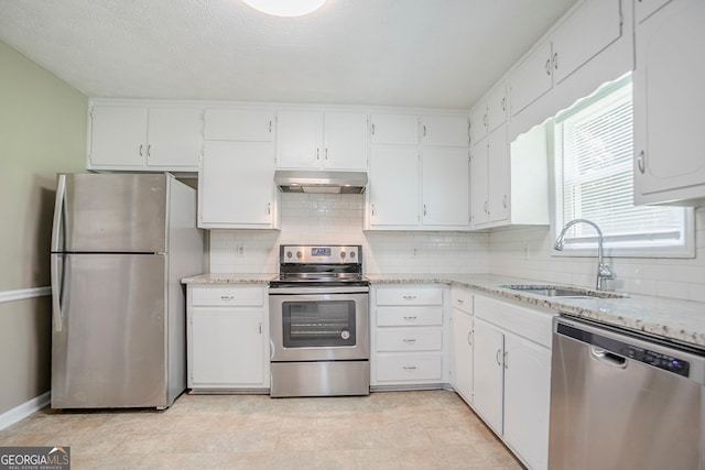 717 Raven Springs Trl, Stone Mountain, GA 30087 - kitchen featuring stainless steel appliances, under cabinet range hood, decorative backsplash, and white cabinets