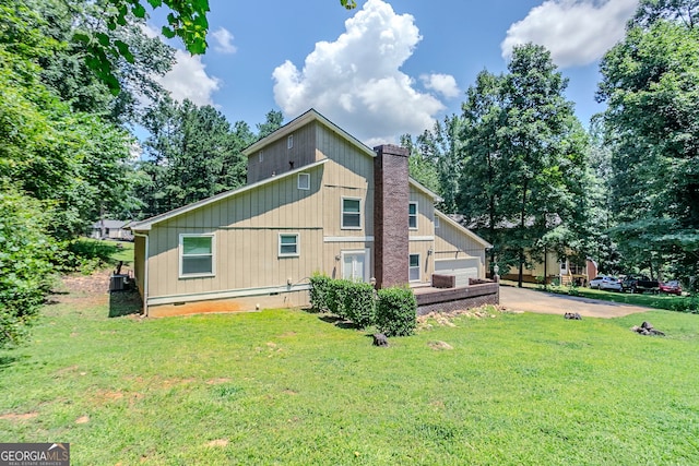 717 Raven Springs Trl, Stone Mountain, GA 30087 - view of side of home featuring a lawn, a chimney, and crawl space
