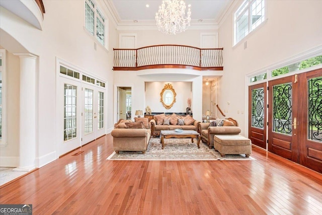 311 N Rivoli Farms Dr, Macon, GA 31210 - foyer entrance with french doors, a high ceiling, hardwood / wood-style flooring, a chandelier, and arched walkways