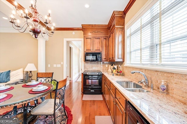 311 N Rivoli Farms Dr, Macon, GA 31210 - kitchen with black appliances, brown cabinetry, backsplash, crown molding, and light stone counters