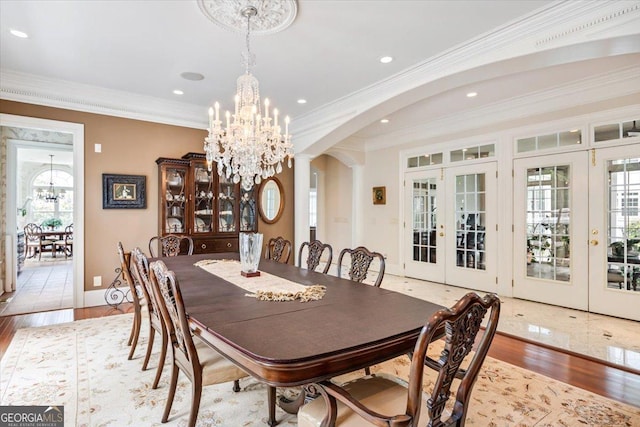311 N Rivoli Farms Dr, Macon, GA 31210 - dining area featuring french doors, a chandelier, crown molding, arched walkways, and wood finished floors