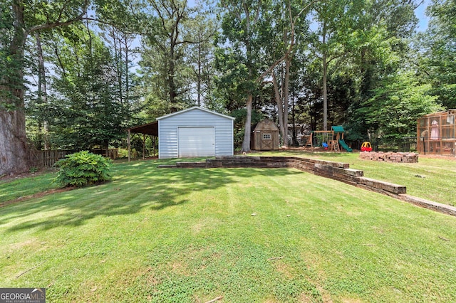 4829 Caboose Ln NW, Acworth, GA 30102 - view of yard featuring a playground, a storage unit, a detached garage, and view of scattered trees