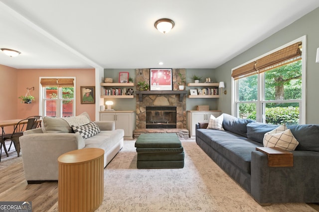 4829 Caboose Ln NW, Acworth, GA 30102 - living room featuring wood finished floors, plenty of natural light, and a stone fireplace