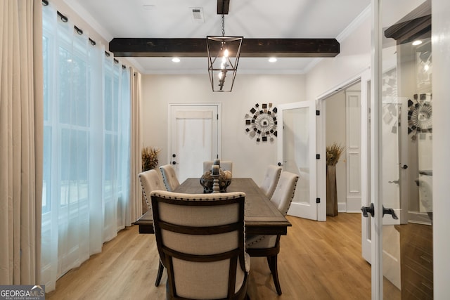 896 Bobby Jones Dr, Dublin, GA 31021 - dining space featuring light wood-style flooring, beam ceiling, french doors, plenty of natural light, and ornamental molding