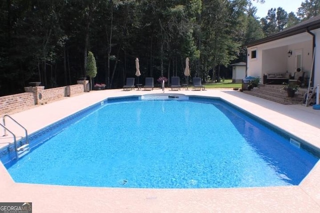 896 Bobby Jones Dr, Dublin, GA 31021 - outdoor pool featuring a patio area and view of scattered trees