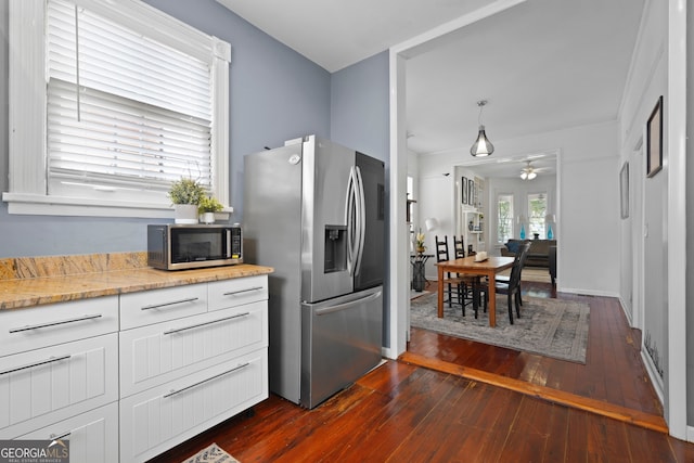 303 W 39th St, Savannah, GA 31405 - kitchen with stainless steel appliances, dark wood finished floors, ceiling fan, white cabinets, and light stone counters