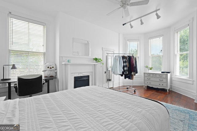 303 W 39th St, Savannah, GA 31405 - bedroom with track lighting, hardwood / wood-style floors, a fireplace, and ceiling fan