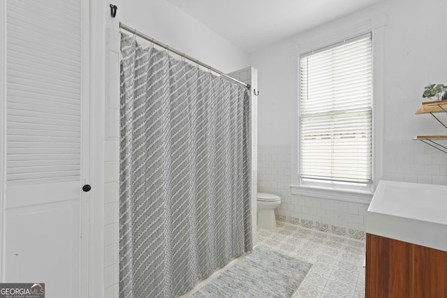 303 W 39th St, Savannah, GA 31405 - full bathroom featuring tile walls, tile patterned flooring, vanity, curtained shower, and wainscoting