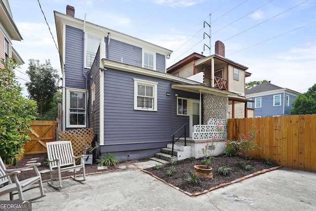 303 W 39th St, Savannah, GA 31405 - view of front facade featuring a chimney and a patio area