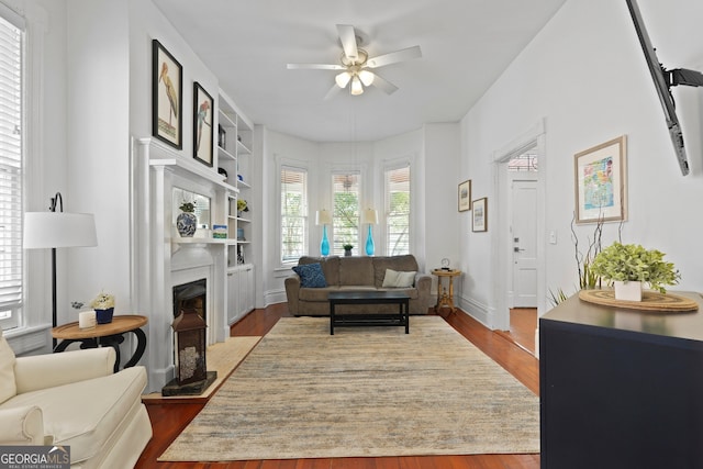303 W 39th St, Savannah, GA 31405 - living room with ceiling fan, wood finished floors, a fireplace, and built in shelves