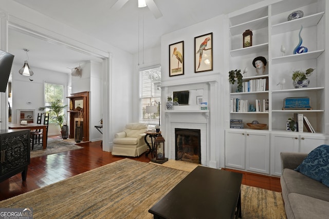 303 W 39th St, Savannah, GA 31405 - living area with a fireplace, dark wood-style floors, ceiling fan, and built in shelves