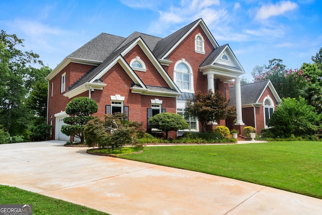 1005 Lyndhurst Way SE, Conyers, GA 30013 - view of front of property with brick siding, driveway, a front yard, and a garage