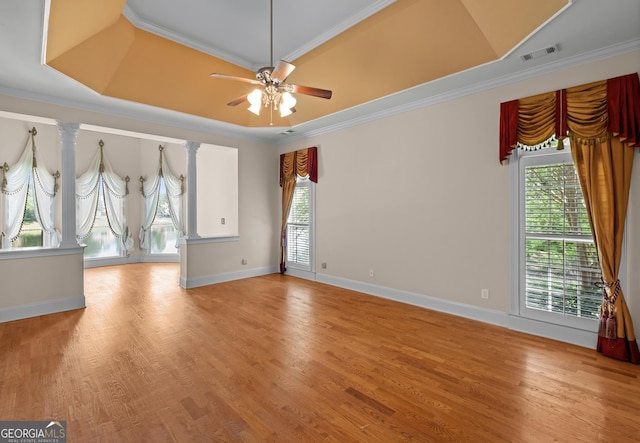 1005 Lyndhurst Way SE, Conyers, GA 30013 - spare room with healthy amount of natural light, a tray ceiling, light wood-style floors, ceiling fan, and crown molding