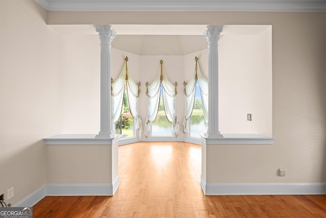 1005 Lyndhurst Way SE, Conyers, GA 30013 - spare room with ornate columns, wood finished floors, and ornamental molding