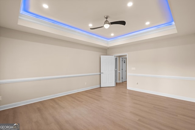 1005 Lyndhurst Way SE, Conyers, GA 30013 - unfurnished room featuring a tray ceiling, recessed lighting, ceiling fan, wood finished floors, and ornamental molding