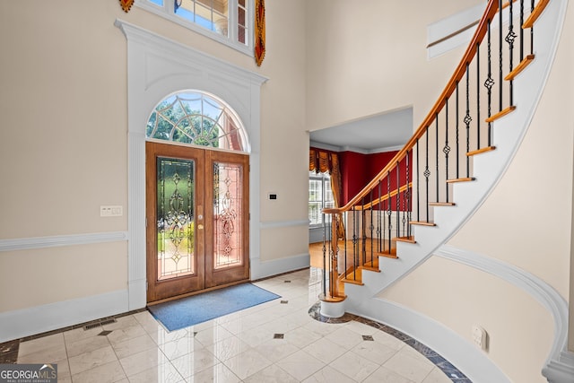 1005 Lyndhurst Way SE, Conyers, GA 30013 - entryway with a high ceiling, inlaid floor details, and stairs