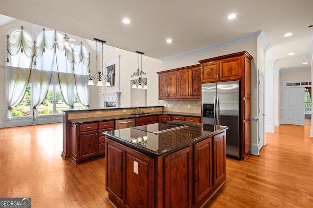 1005 Lyndhurst Way SE, Conyers, GA 30013 - kitchen featuring appliances with stainless steel finishes, a peninsula, light wood-type flooring, ornamental molding, and a kitchen island