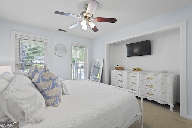 126 S Sheftall Cir, Savannah, GA 31410 - bedroom featuring light colored carpet, ceiling fan, and a textured ceiling