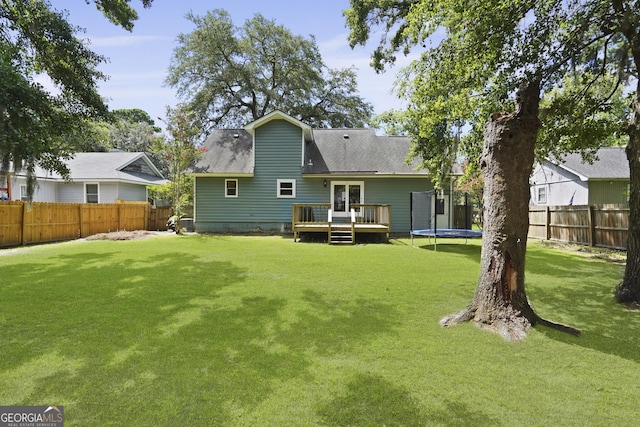 126 S Sheftall Cir, Savannah, GA 31410 - rear view of property featuring a deck, a trampoline, a fenced backyard, and roof with shingles