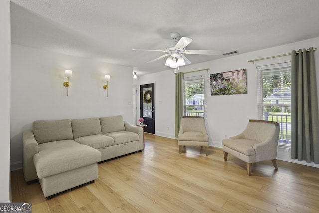 126 S Sheftall Cir, Savannah, GA 31410 - living room featuring a ceiling fan, light wood-type flooring, and a textured ceiling