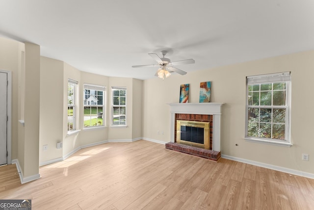 4015 Snowshoe Ct NW, Acworth, GA 30101 - unfurnished living room featuring light wood-style floors, plenty of natural light, ceiling fan, and a fireplace
