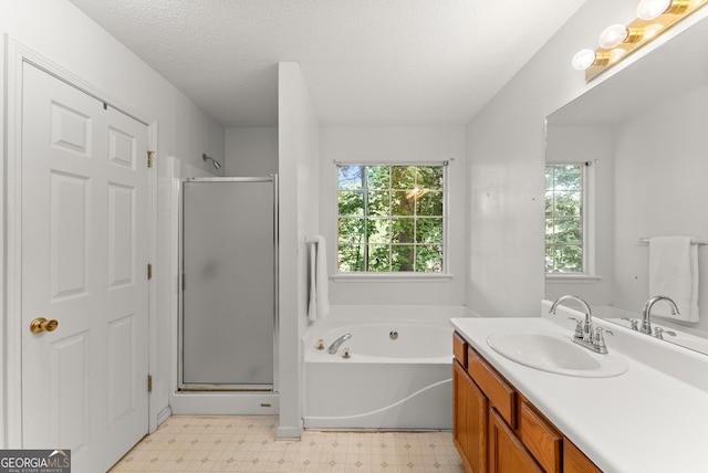 4015 Snowshoe Ct NW, Acworth, GA 30101 - full bath with tile patterned floors, a stall shower, vanity, a garden tub, and a textured ceiling