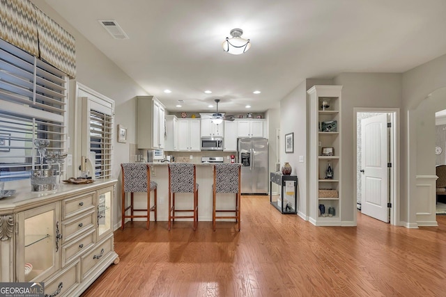 236 Creek View Ln, Acworth, GA 30102 - kitchen with stainless steel appliances, ceiling fan, light wood-style flooring, recessed lighting, and a peninsula