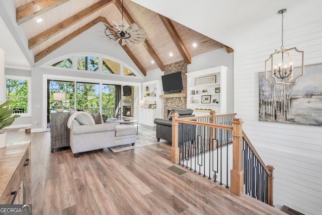 123 River Point Rd, Jackson, GA 30233 - living area featuring a chandelier, high vaulted ceiling, wood finished floors, a stone fireplace, and recessed lighting