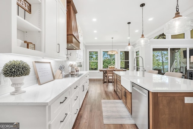 123 River Point Rd, Jackson, GA 30233 - kitchen with stainless steel dishwasher, plenty of natural light, brown cabinets, light wood finished floors, and crown molding